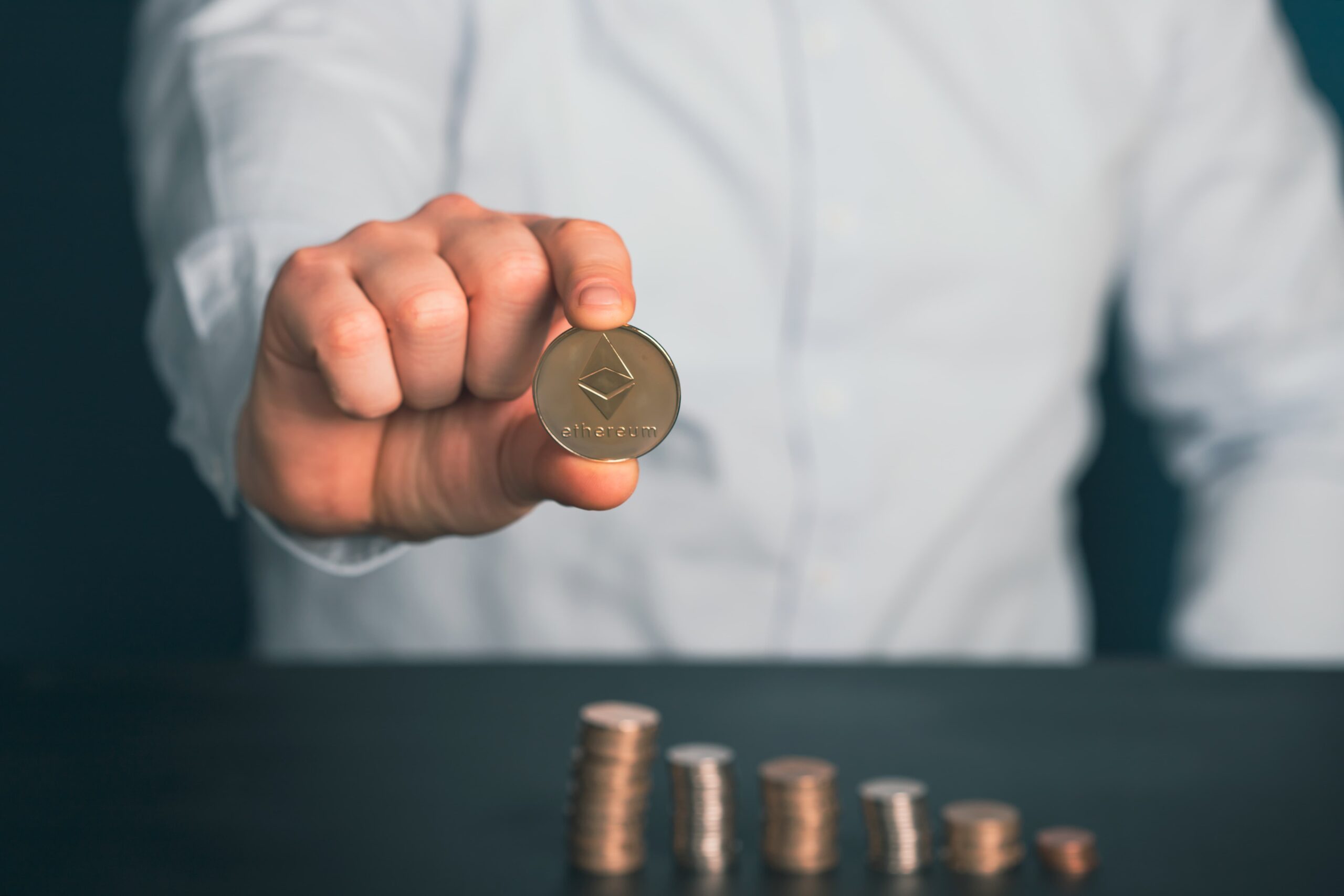 businessman-holding-ethereum-cryptocurrency-coin-2022-04-01-18-11-04-utc-min